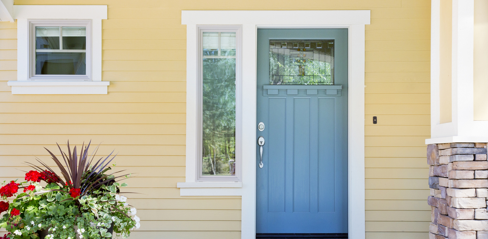 Front entrance of a home with blue door Slide Image #1